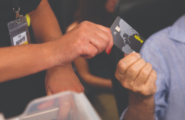 Photo of someone paying with a Spirit Credit card