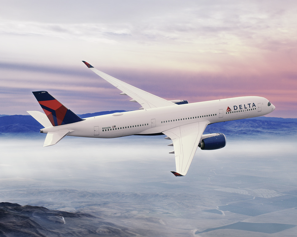 Delta A350 flying with pink and blue skies in the background.