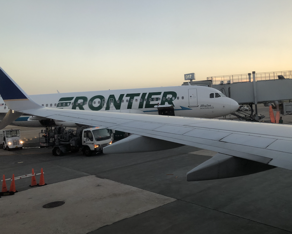 Frontier Airlines jet parked at a gate.