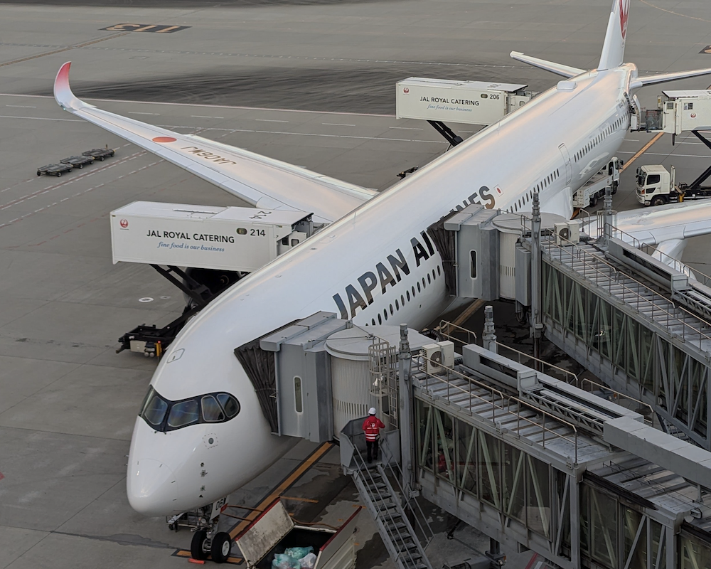 Japan Airlines A350 parked at a gate.