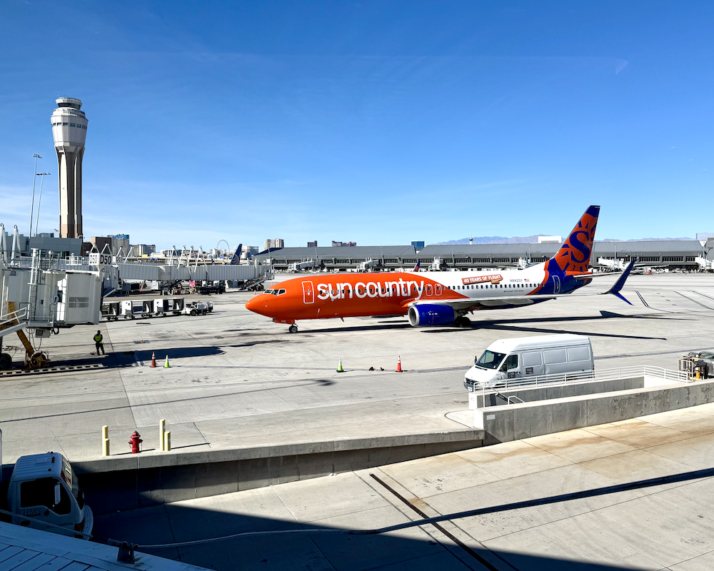 Sun Country jet pulling into a gate -- as seen from the Capital One Lounge Las Vegas.