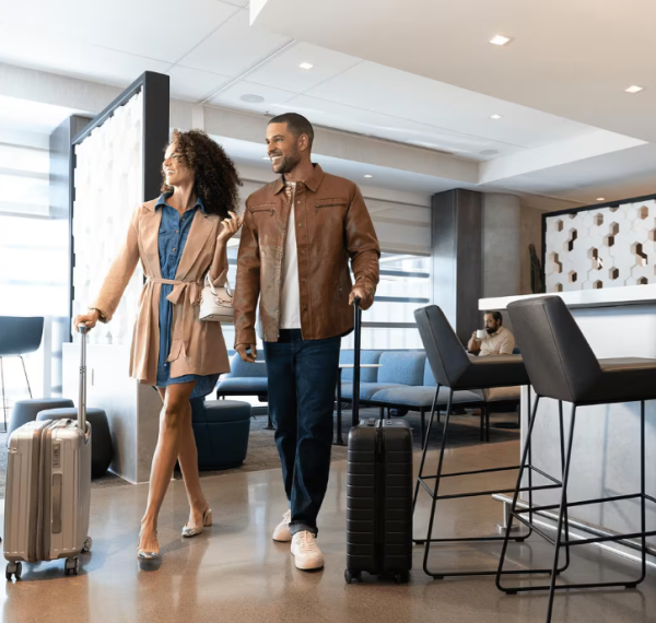 A photo shows a couple walking through a United Club lounge