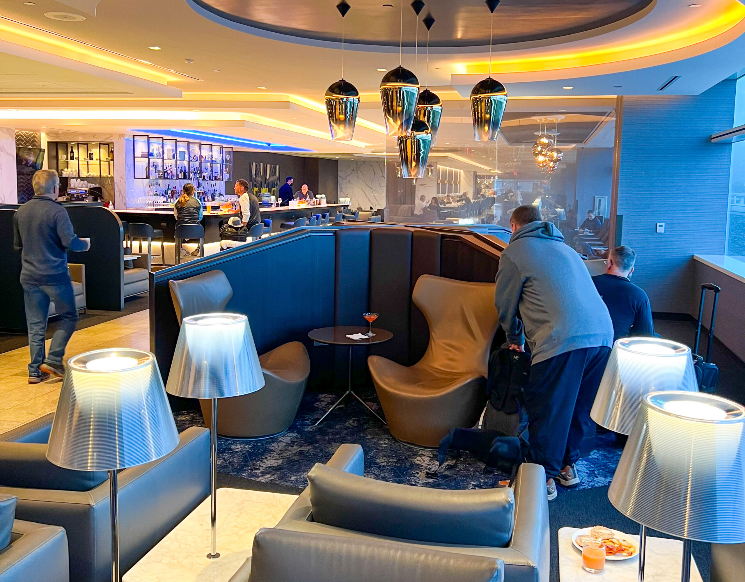 The United Polaris Lounge San Francisco with lounge chairs and a bar.