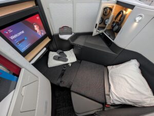 American Airlines Flagship Suite on Boeing 787-9P, fully reclined with amenities and privacy divider closed