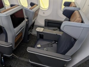 American Airlines Boeing 787-9P premium economy row with seat reclined into it