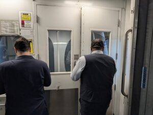 American Airlines jet bridge door closed with the aircraft door closed on the other side