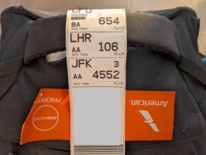 American Airlines priority bag tag showing AA flight 106 for the segment from New York to London