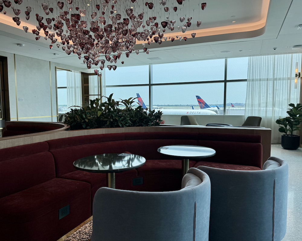 Capital One Lounge at JFK chandelier and tarmac views.