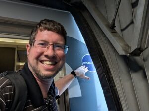 Selfie of JT Genter at the boarding door of flight AA106
