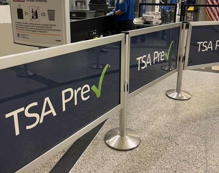 A photo shows a TSA precheck sign in an airport