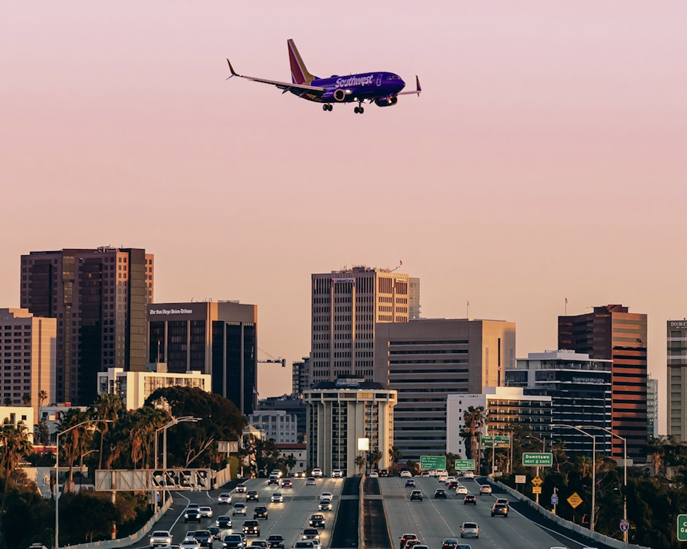 Southwest Airlines 737 landing at San Diego with a pink sky background.