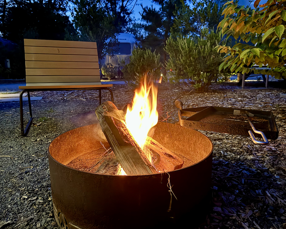 Lighting a fire in the fire pit at AutoCamp Cape Cod