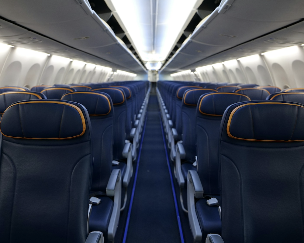 Wide-angle photo of an airplane's economy cabin.