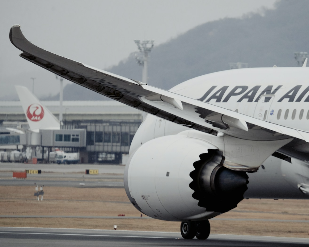 Close-up of a Japan Airlines 787 taxiing in cloudy conditions.