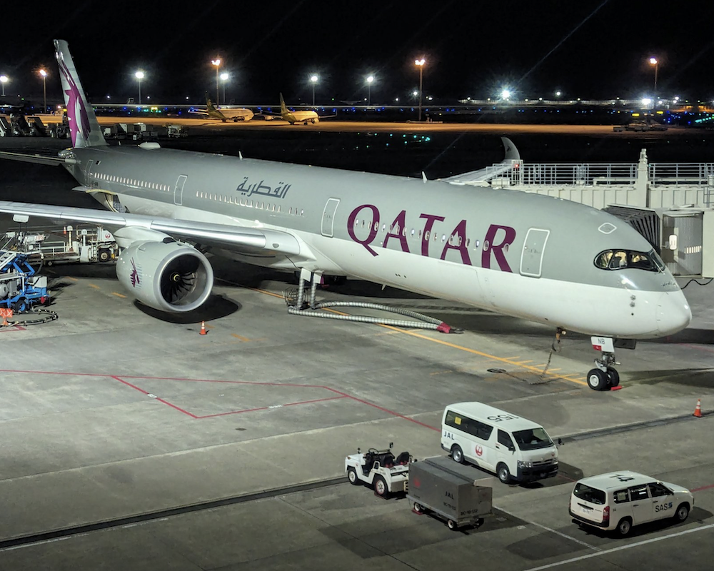 Qatar Airways A350-1000 at a gate.