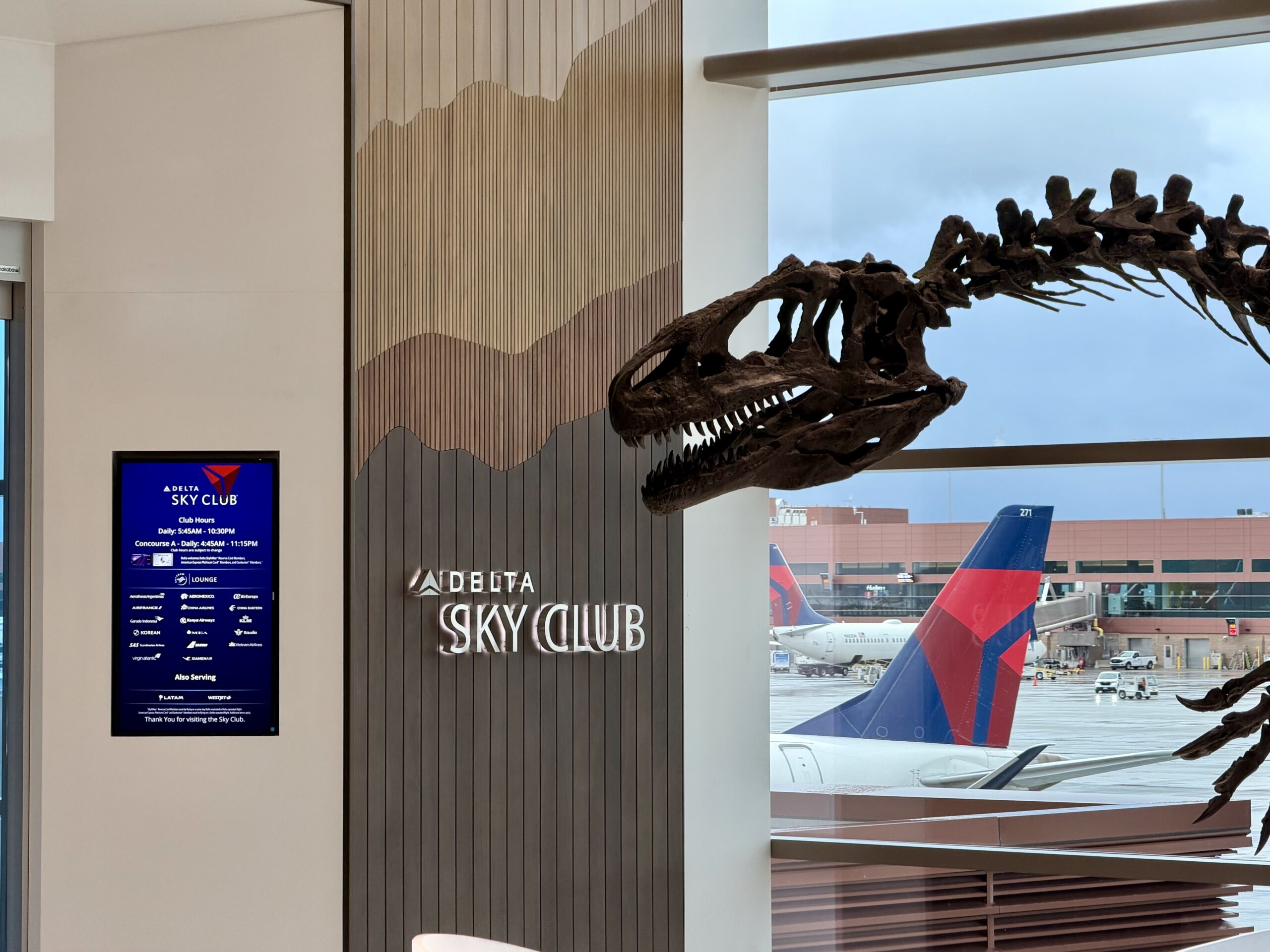 Delta Sky Club SLC Concourse B entryway and dinosaur.