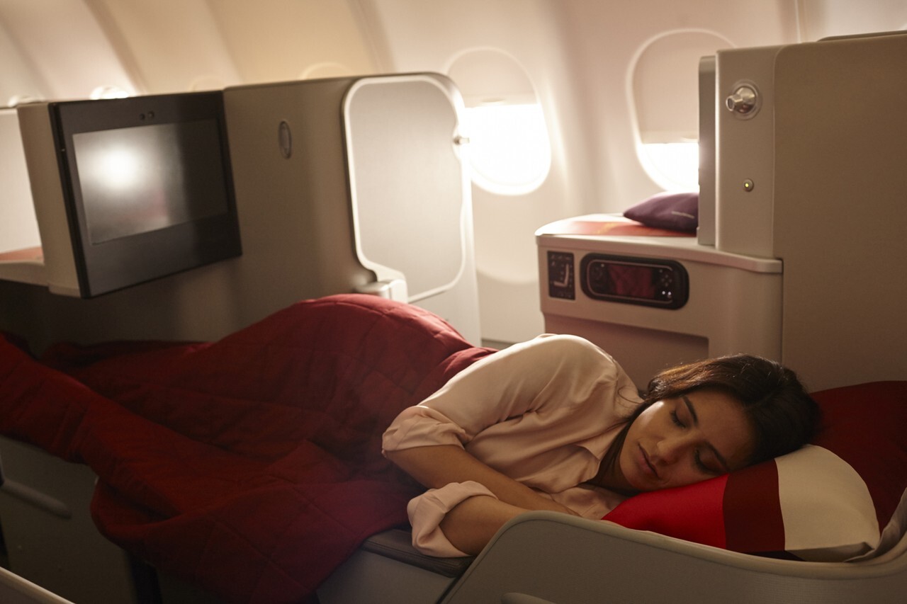 A woman sleeping in Iberia's business class seat