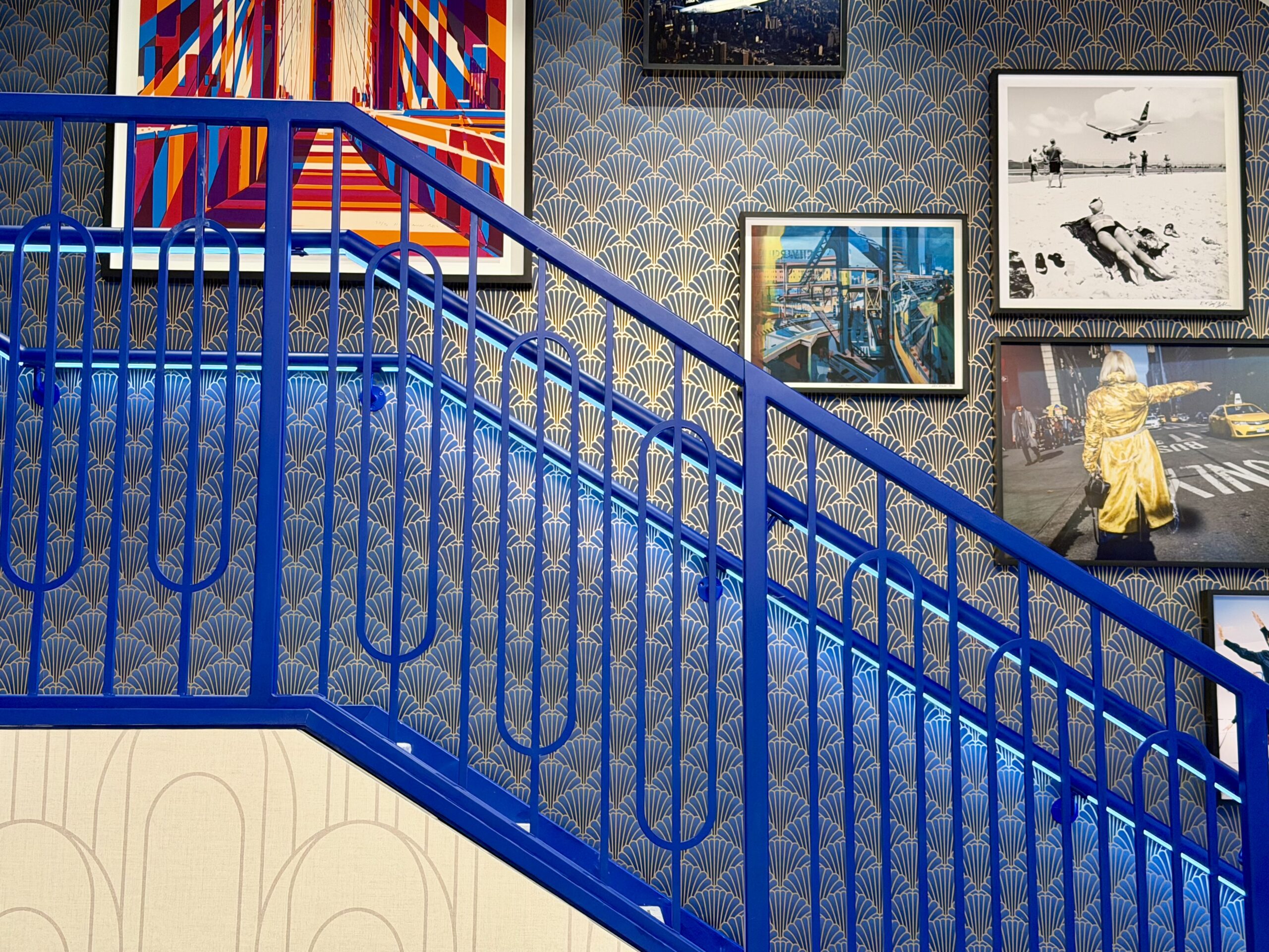 JFK BlueHouse lounge stairs and artwork.