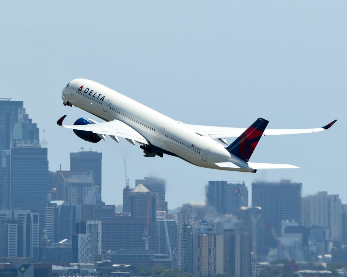 Featured- Delta wide body jet climbing after take off