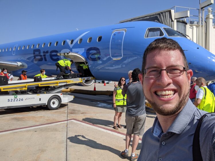 Photo of JT Genter in front of Breeze inaugural flight
