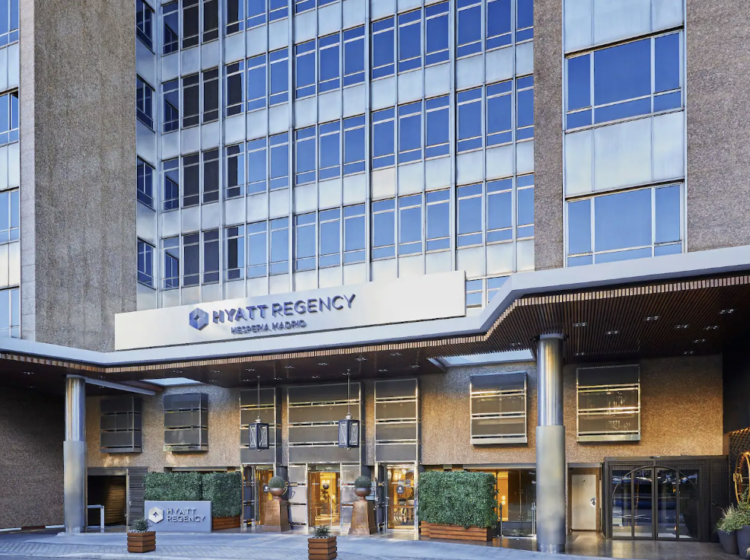 Hyatt Regency Hespera Madrid front entrance with hanging lanterns and boxwood bushes 