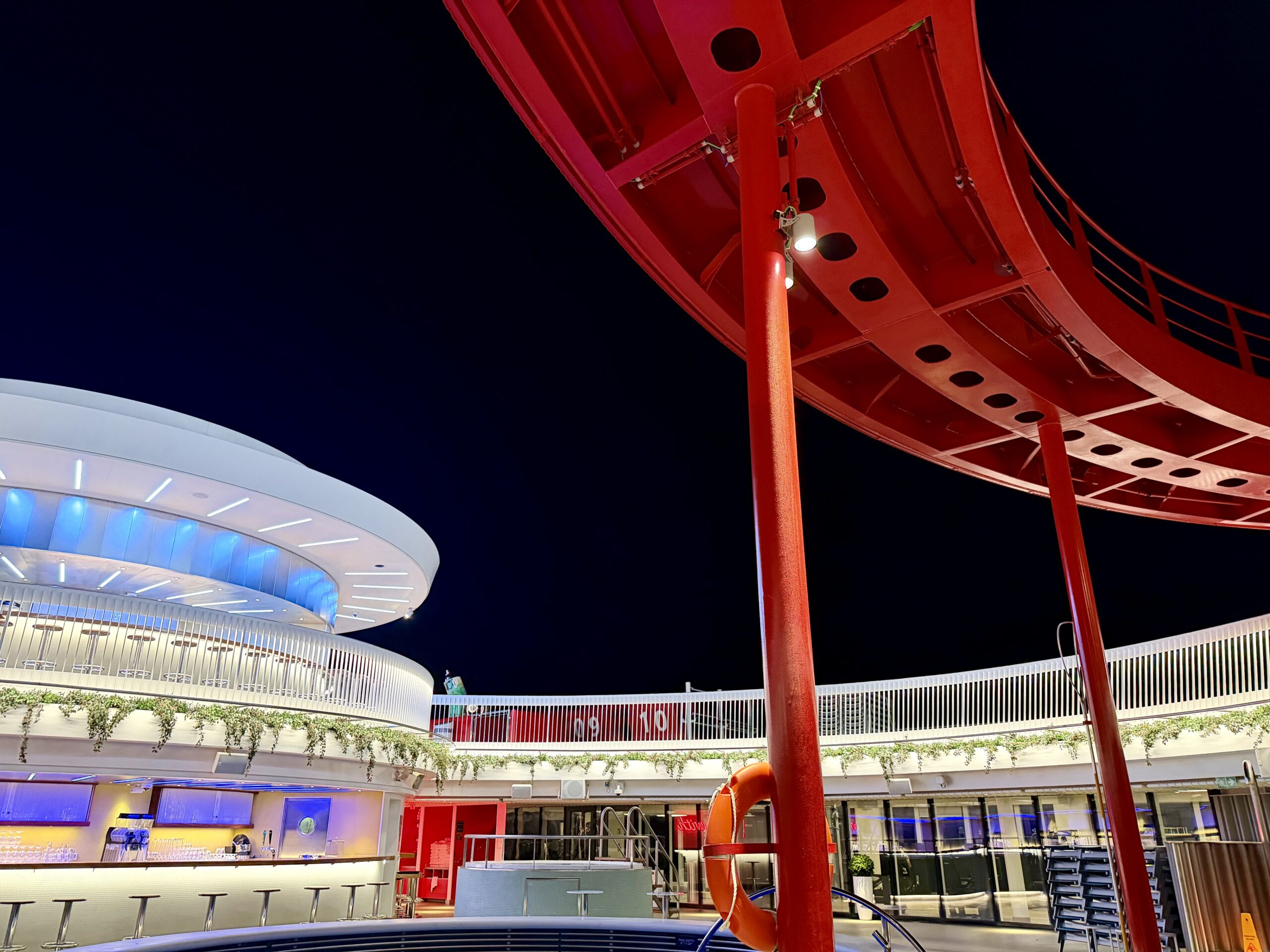 Virgin Voyages pool deck at night.