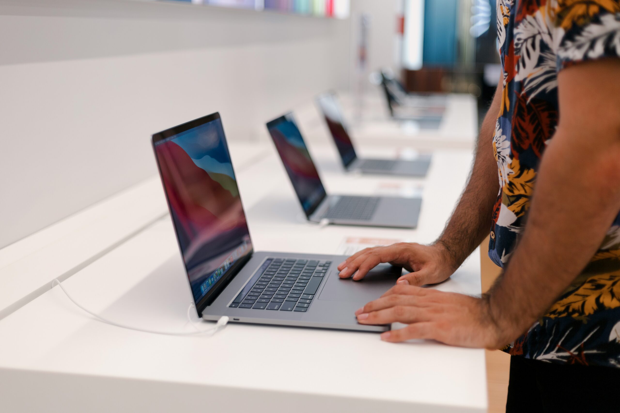 Person using a Macbook at an Apple store