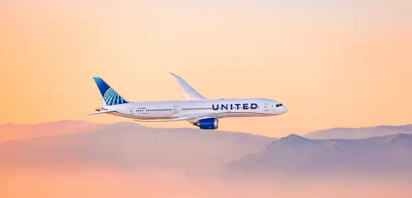 United airplane flying at sunset