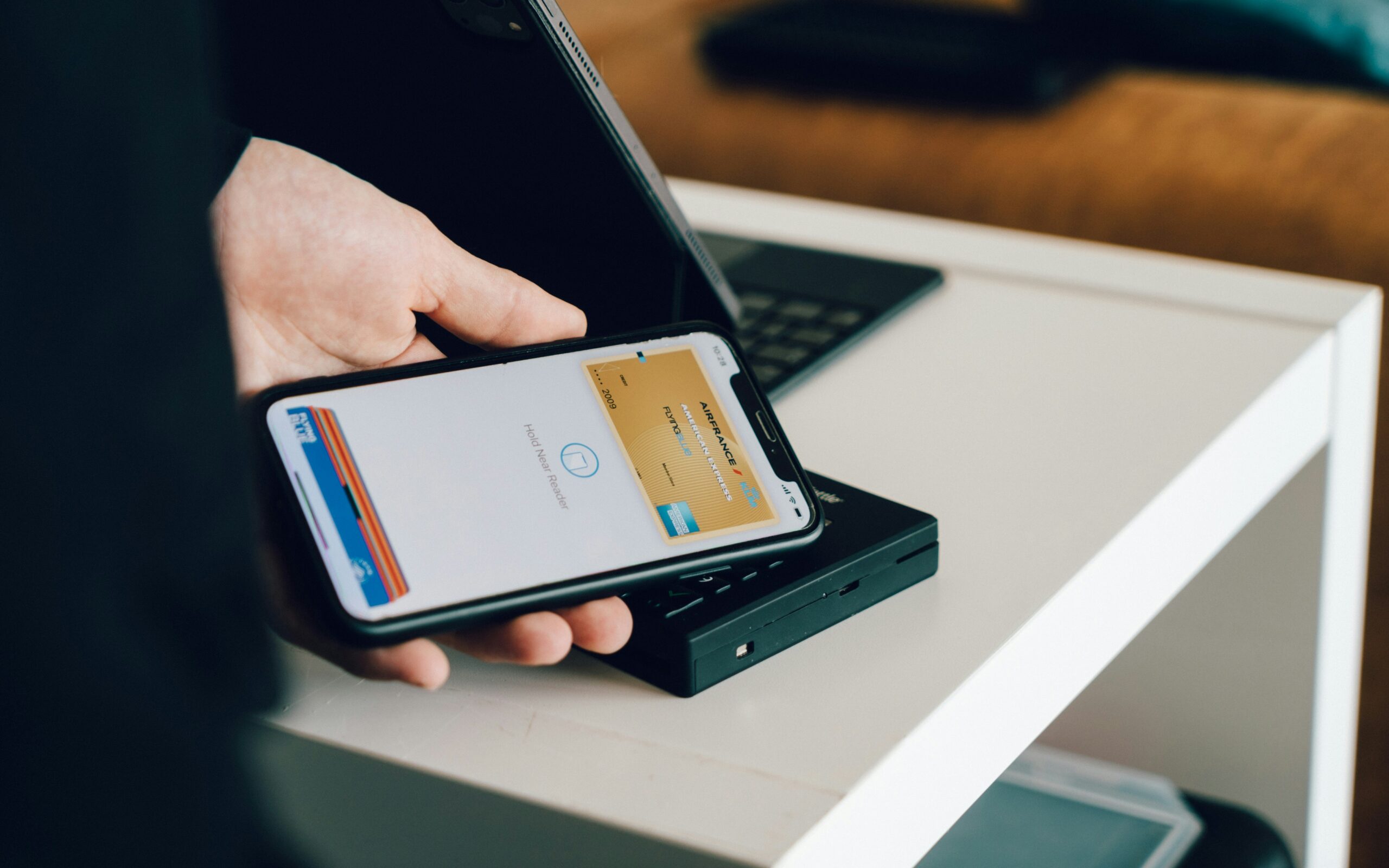 Person using Apple Pay at a POS terminal