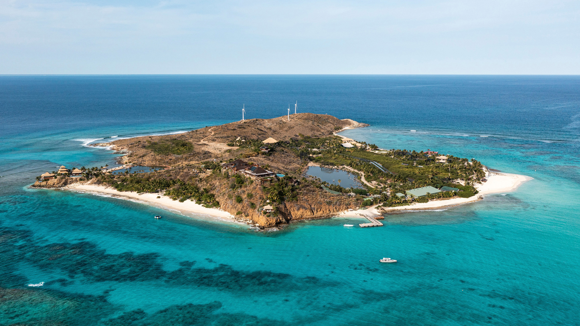 Small island surrounded by vibrant blue water