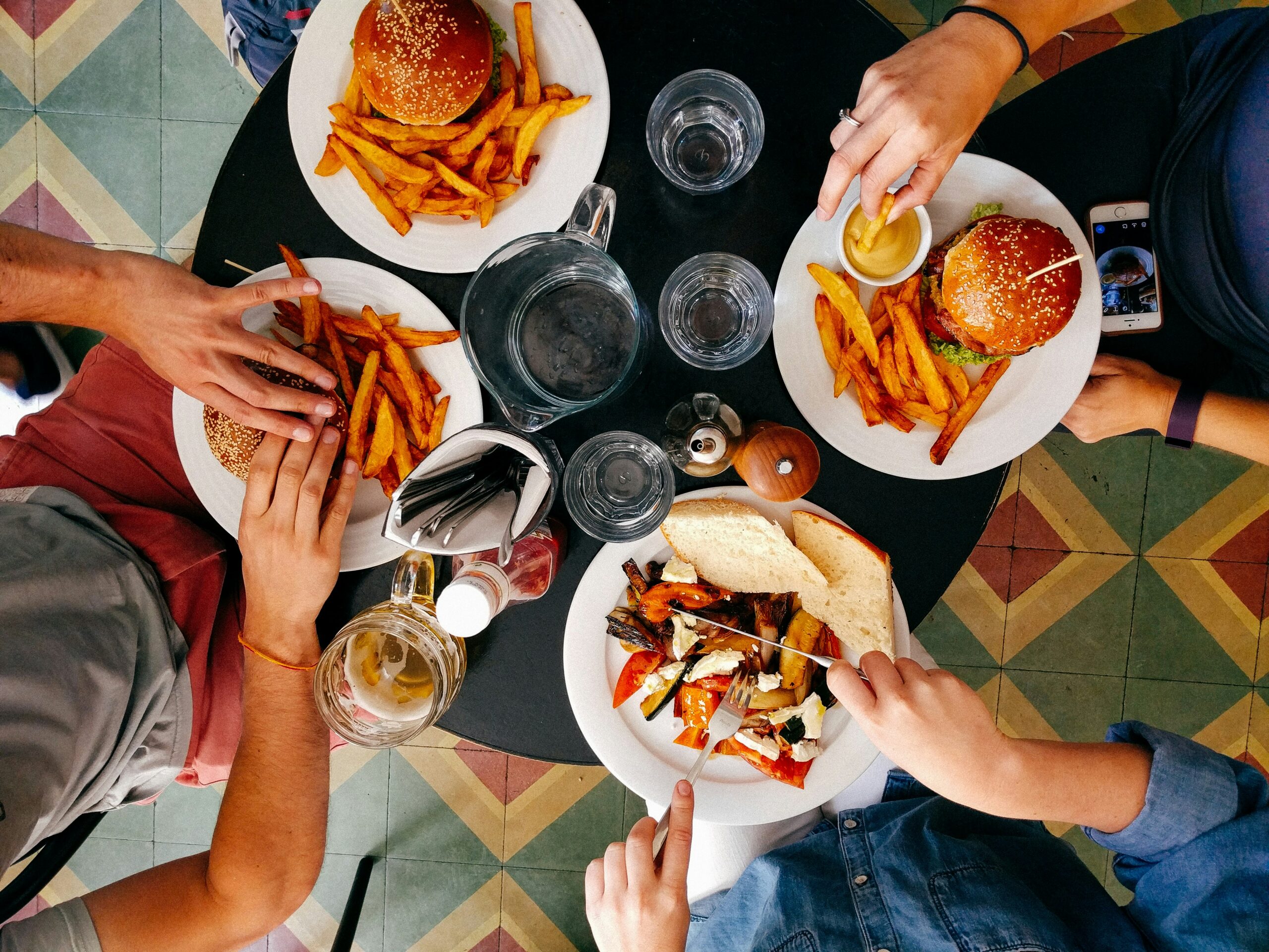 Four people sitting at a table eating lunch