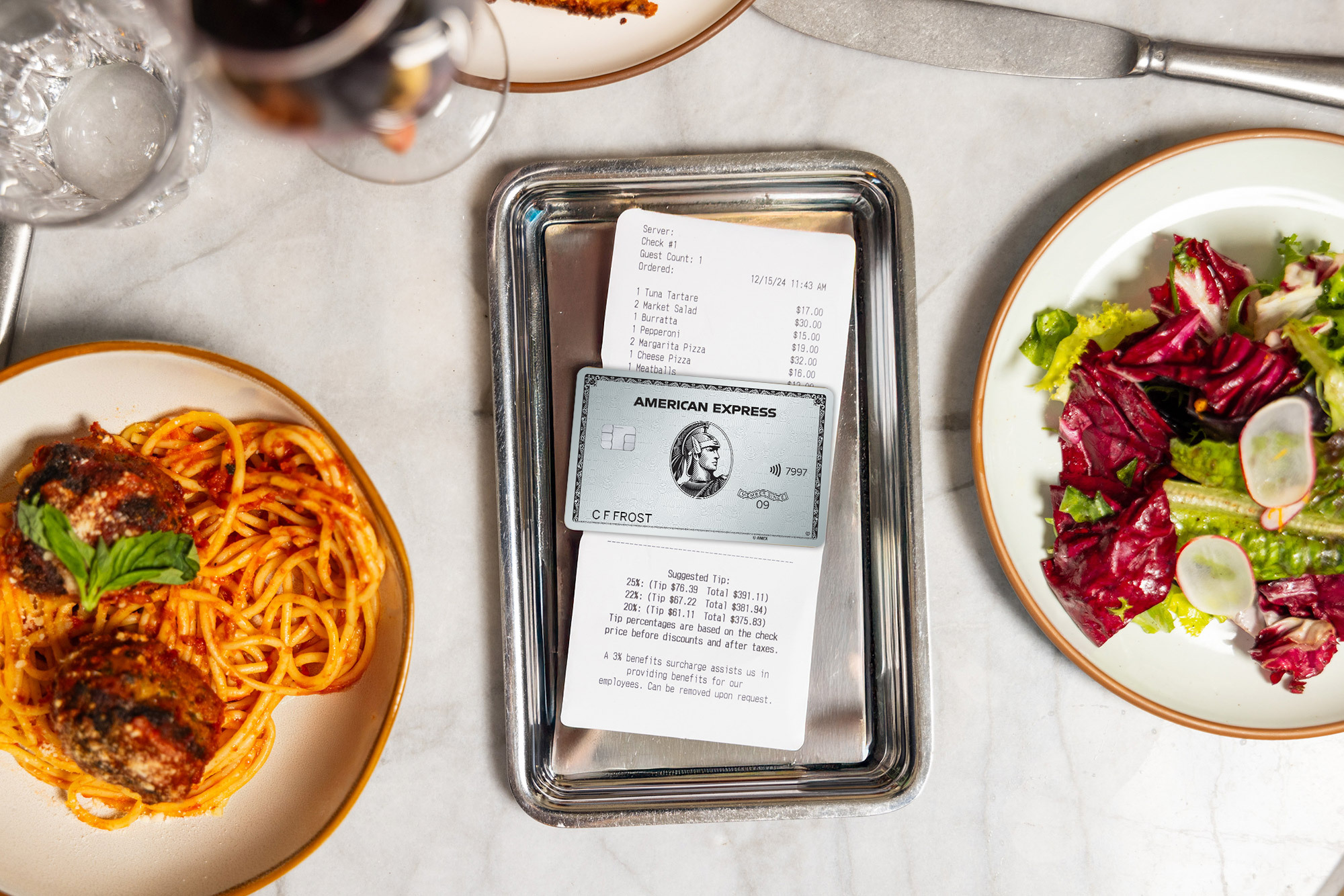 Amex Platinum Card on a table surrounded by food