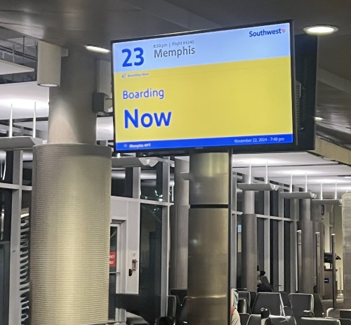 A Southwest gate with a now boarding for a flight to Memphis.